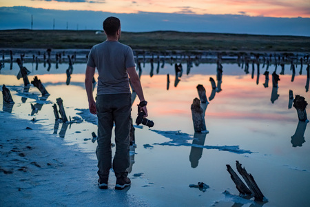 Back view male outdoor photographer at salt lake Baskunchak in Russiaの写真素材