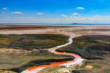 Amazing aerial view of small red water river in Bogdo-Baskunchak Nature Reserve