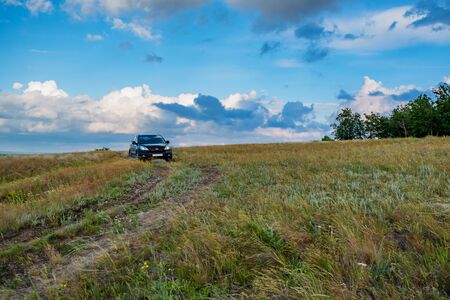 ROSTOV-ON-DON, RUSSIA - JUNE 21, 2017: Crossover parked in the coutry on steppe road in summerのeditorial素材