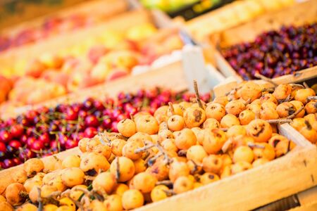 Loquat fruit or Japanese medlars for sale on fruit marketの写真素材