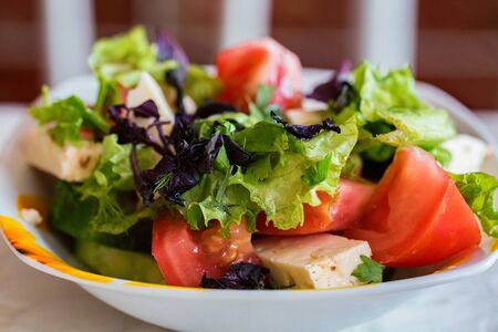 Greek salad with fresh vegetables in plate closeの写真素材