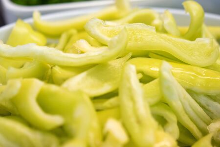 Close up slices of green bell pepper on plateの写真素材