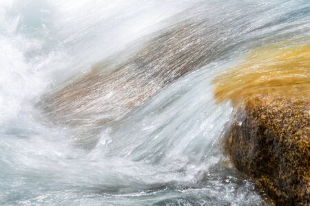 Beautiful peaceful view of water in mountain river. Slow shutter speed