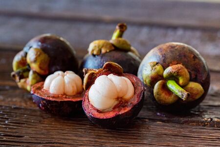 Mangosteen fruit on wooden table close upの写真素材