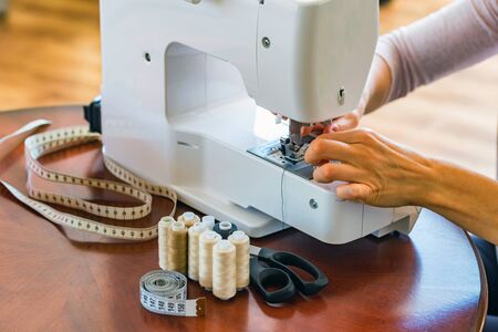 Dressmaker or seamstress works using sewing machine