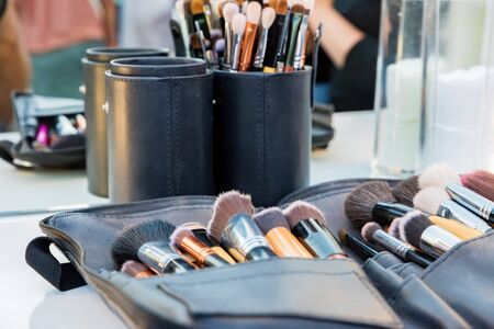 Close up various professional make up brushes lying in dark caseの写真素材