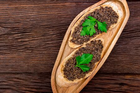 Fresh tasty bruschetta with truffle sauce and parsley. Top view