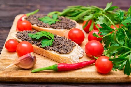 Fresh tasty bruschetta with truffle sauce, chili, parsley and tomatesの写真素材