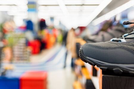Close view of single sports shoe for sale in sports shop. Defocused background. Sports equipment conceptの写真素材