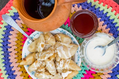 Dumplings or vareniki with stuffing served with jam and sour cream. Top viewの写真素材