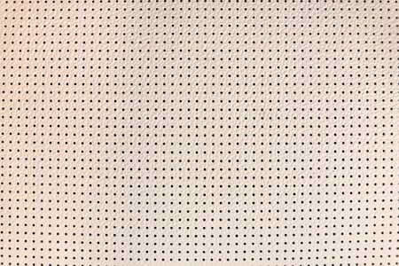 Light beige perforated leather texture close upの写真素材