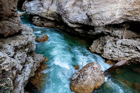 Fall landscape with quick narrow mountain river with clean waterの写真素材