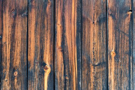 Close-up texture of dark wooden planks with some spaces between themの写真素材