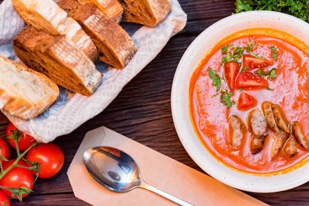 Top view tomato soup with meat and spices on wooden surface. Selective focusの写真素材