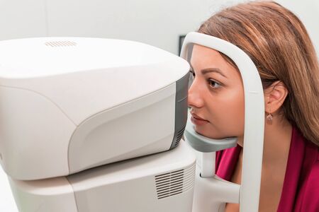 Measuring young womans eye pressure with tonometer