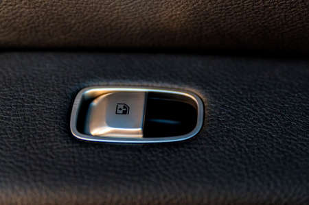 Close up black window lifter button in luxury car