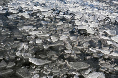 Pieces of ice on water surface in winter
