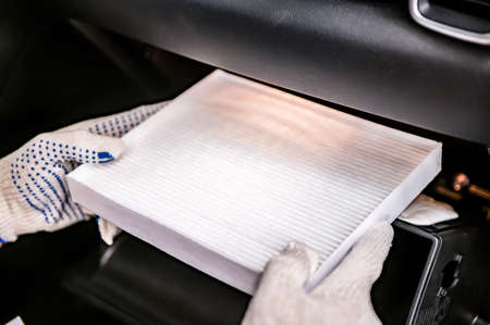 Hand of mechanik is holds new car cabin filterの写真素材