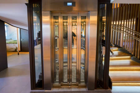 Lift with transparent glass doors in modern building