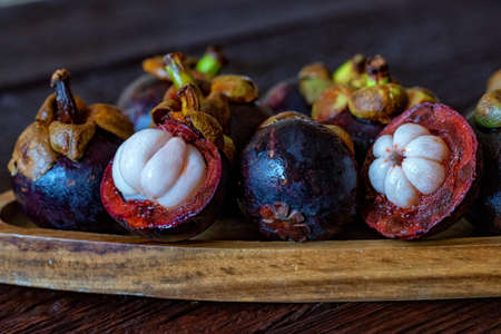 Mangosteen fruit on wooden table close upの写真素材