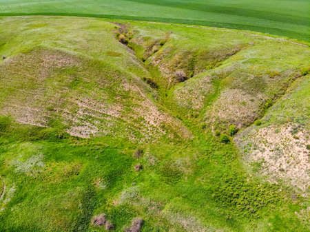 Landskape drone view on green ravine in spring sunny day at steppe