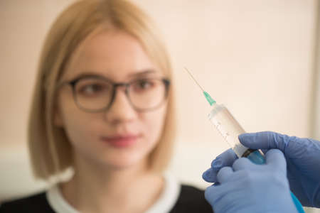 Girl shows she is afraid of injectionの写真素材