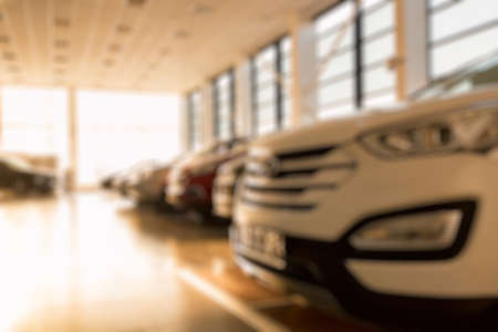 New cars at sunlit dealer showroom close view