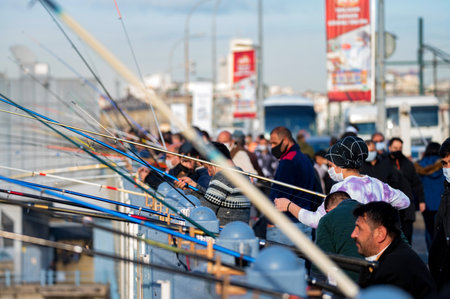 ISTANBUL, TURKEY - 9 DECEMBER 2020: fishermans and fisherwoman on Galata Bridgeのeditorial素材