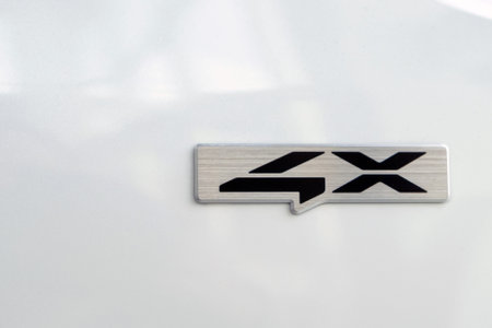 Close-up of four wheel drive sign on a carの写真素材