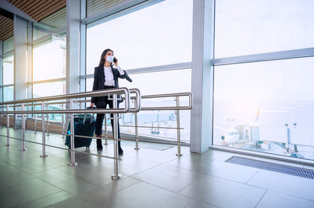 Woman with luggage walks at the airport. Travel conceptの写真素材