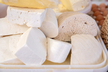 Homemade Caucasian cheese or Bryndza cut in slices at local market