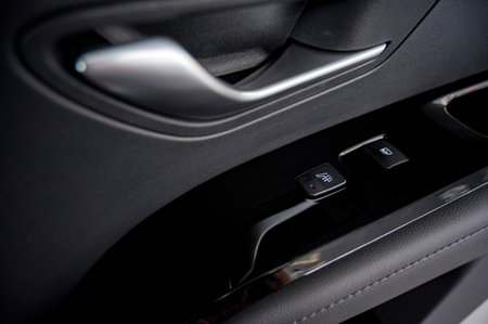 Business car window control buttons. Interior details.