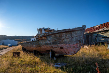 An old abandoned fishing boat near the house.の写真素材