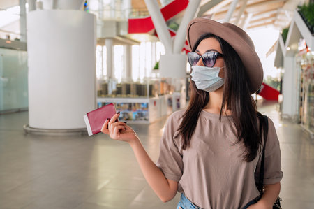 Girl at the airport window waits for a flightの写真素材