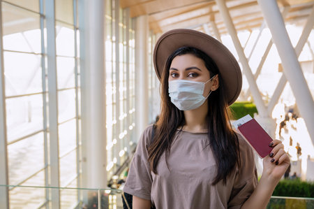 Girl at the airport window waits for a flightの写真素材