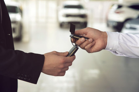 Car salesman gives the keys to the customers who signed the purchase contractの写真素材