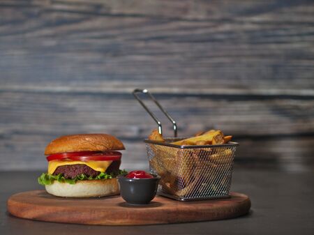 vegan plant based burger with fries served on wooden trayの写真素材