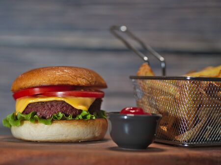 vegan plant based burger with fries served on wooden trayの写真素材