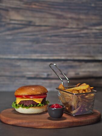 vegan plant based burger with fries served on wooden trayの写真素材
