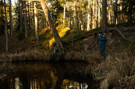 Fisherman angler  fishing forest river blue costume try catch troutの写真素材