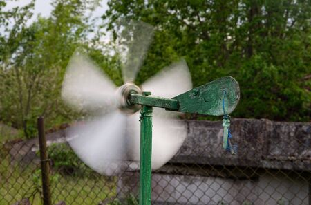 Garden propellers spin in high winds, green