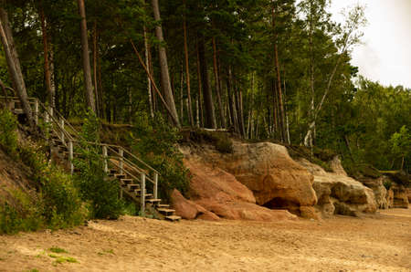 Seaside caves with cliffs and wooden stairs, summerの写真素材