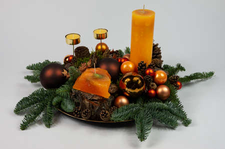 Christmas Advent composition with cones and candles on a tray, snowの写真素材