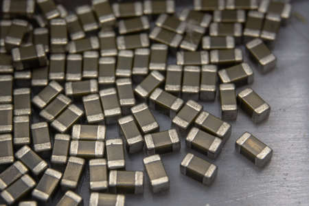 Abstract close-up of 0603 SMT surface mount MLCC capacitors electronics components random scatter in storage containerの写真素材