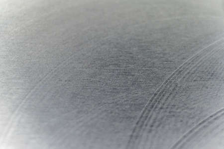 Closeup industrial realistic gray color stainless steel flat part partial focus after industrial CNC routing processing high contrast abstract light reflections narrow high detail linesの写真素材