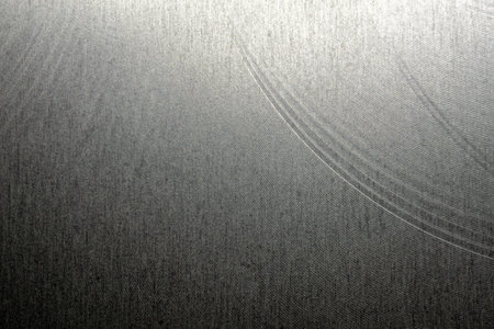 Closeup industrial realistic gray color stainless steel flat part partial focus after industrial CNC routing processing high contrast abstract light reflections narrow high detail linesの写真素材