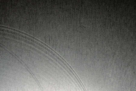 Closeup industrial realistic gray color stainless steel flat part partial focus after industrial CNC routing processing high contrast abstract light reflections narrow high detail linesの写真素材