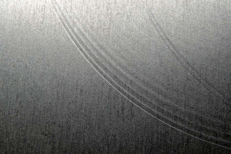 Closeup industrial realistic gray color stainless steel flat part partial focus after industrial CNC routing processing high contrast abstract light reflections narrow high detail linesの写真素材