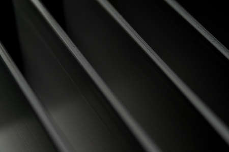 Close-up of industrial realistic gray color aluminum heatsink fins partial focus after industrial CNC routing processing with high contrast abstract light reflectionsの写真素材