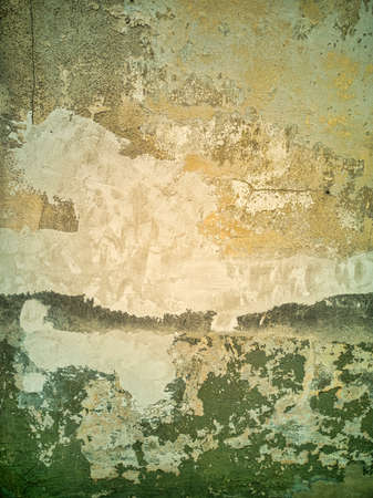 Abstract high contrast colorful isolated close-up of brown aged concrete above wood building showing signs of weather and time wear before restorationの写真素材